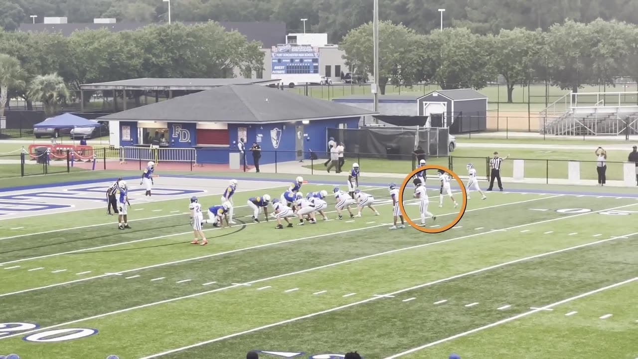 A NextPlay highlight playing on an iPhone: youth football, the athlete marked with an amber ring